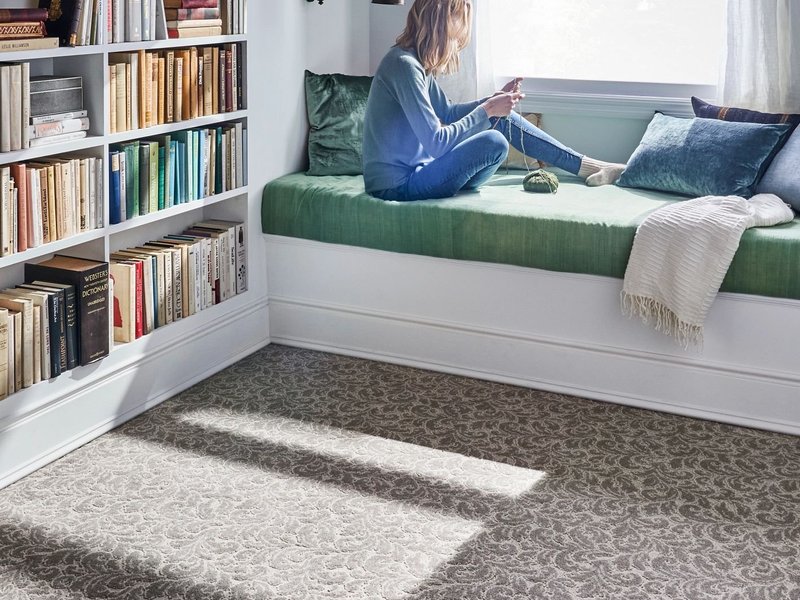 person reading in window from Domenic and Sons Floor Covering in Johnston, RI